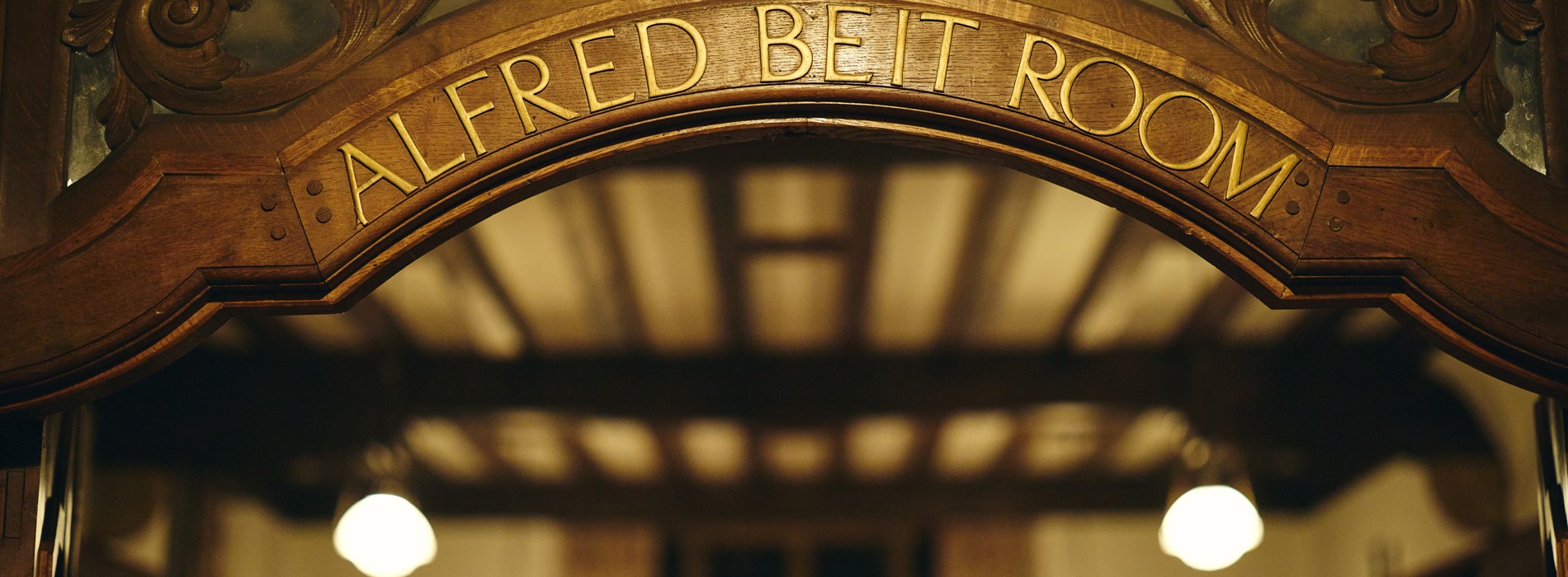 Engraved room name in arch above Beit Room door.