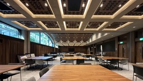 View from the side of the Conference Hall set up cabaret style with square tables.