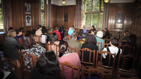 Talk in the Beit Room with guests facing a panel of seated speakers
