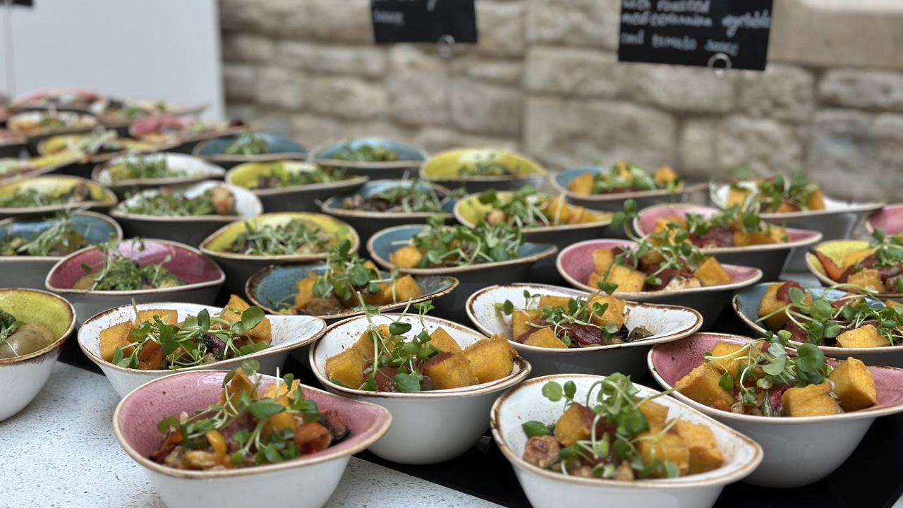 Bowl food set out for a standing delegate lunch.