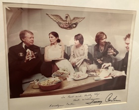 Bob and his wife Betty sitting with Rosalynn and Jimmy Carter and one other woman. The table in front of them is laid out with snacks.