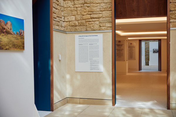 A Plaque On The Wall Explains The Living With The Legacy Of Cecil John Rhodes Photography Exhibition