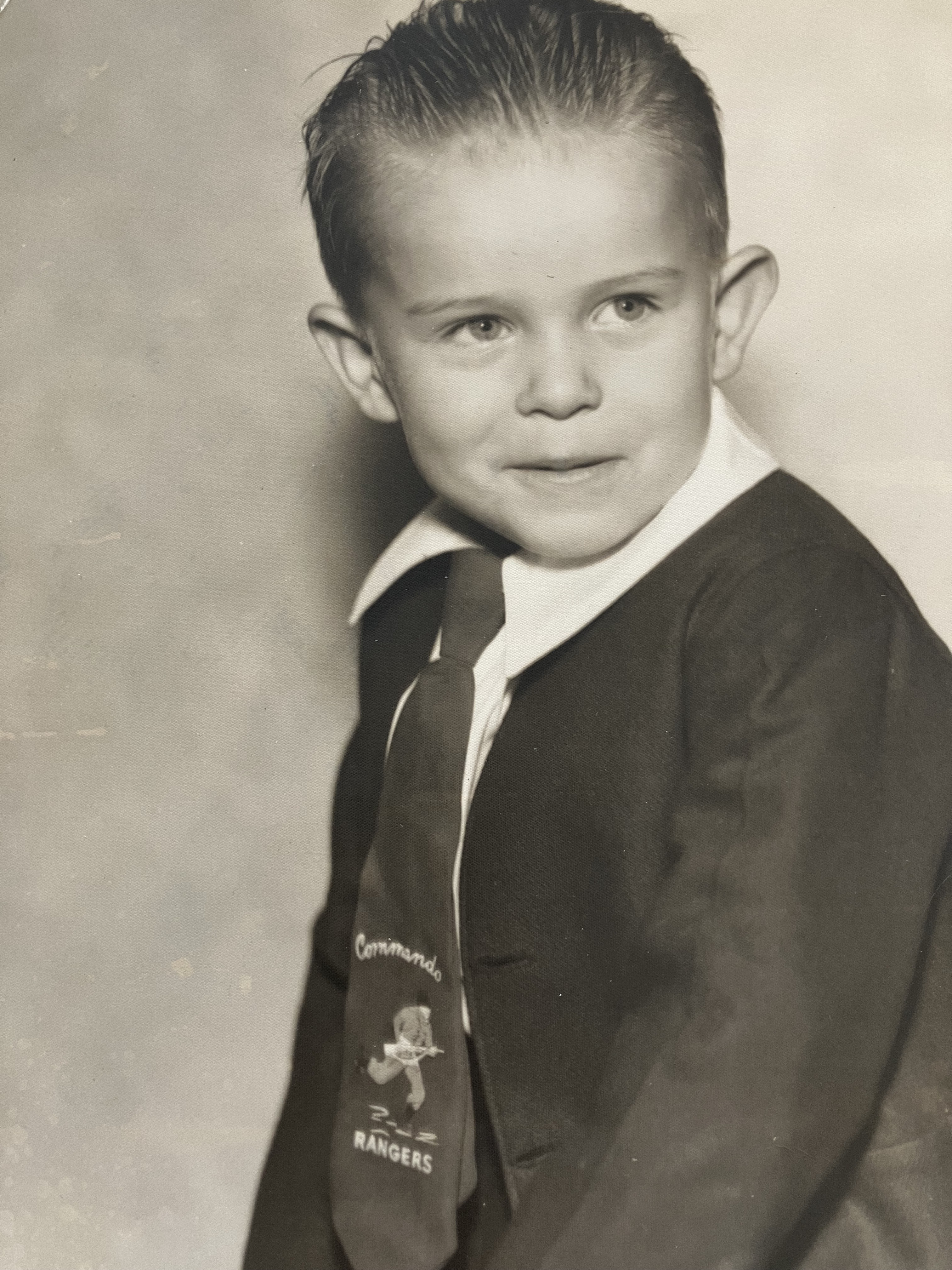A black-and-white picture of Paul as a child in a jacket, and tie
