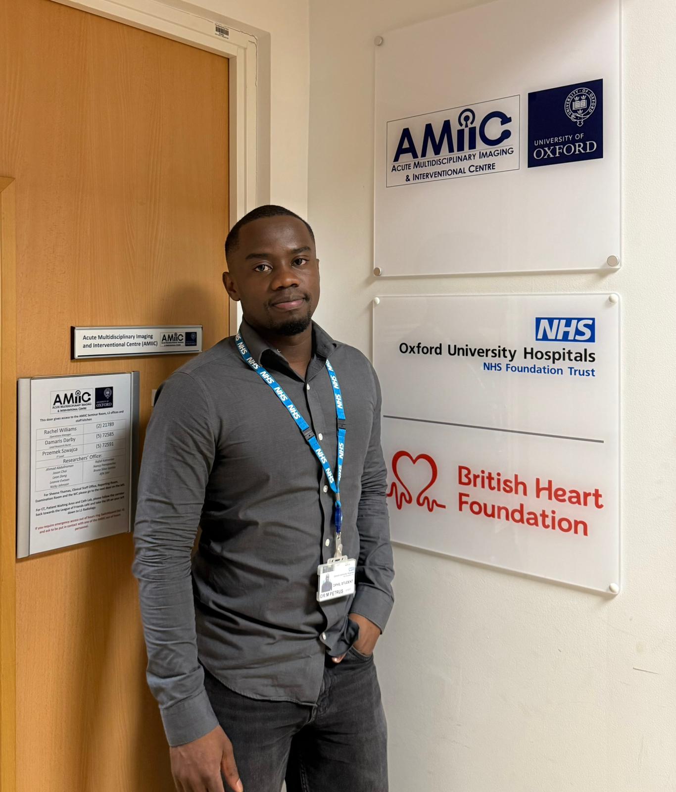 Michael in front of NHS and BHF logos in Oxford