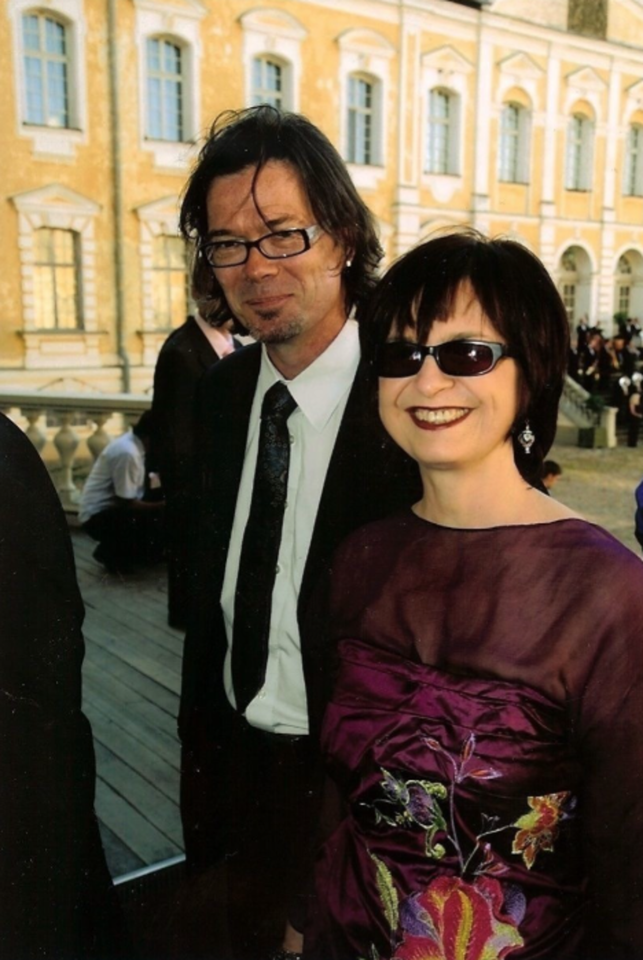 Nic and Banuta stood in a town square smiling dressed in formal attire.