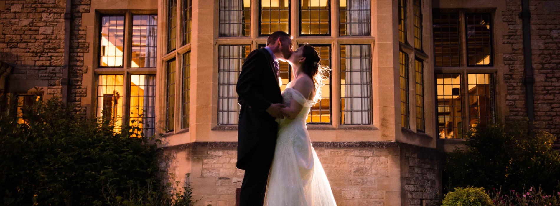 Wedding Couple Kissing at Night Outside the Rhodes House Bay Window
