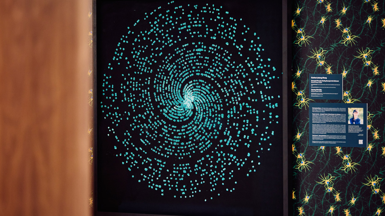 An artwork featuring a blue sparkling spiral contrasted on a black background