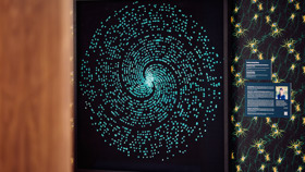 An artwork featuring a blue sparkling spiral contrasted on a black background