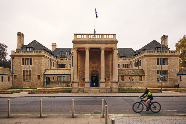 Rhodes House with a bike passing