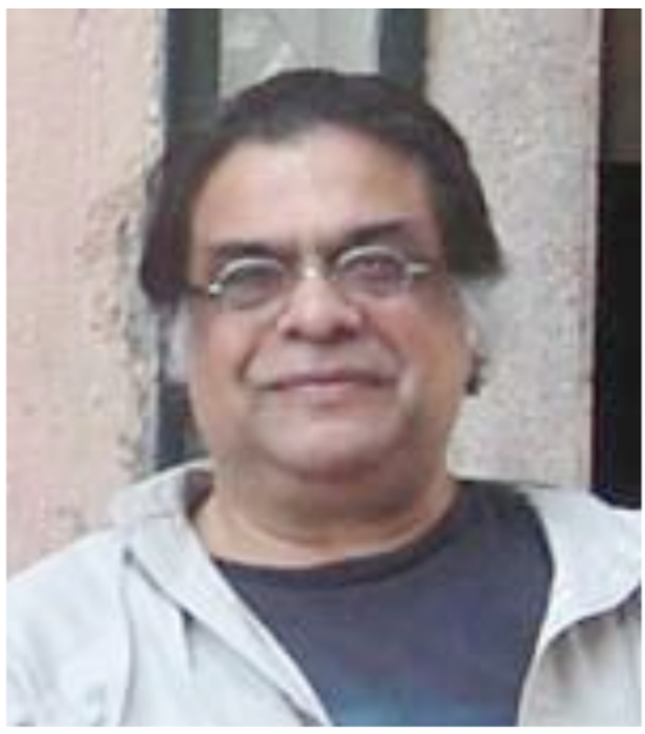 A picture of Jahar wearing round glasses and white hair on the sides.
