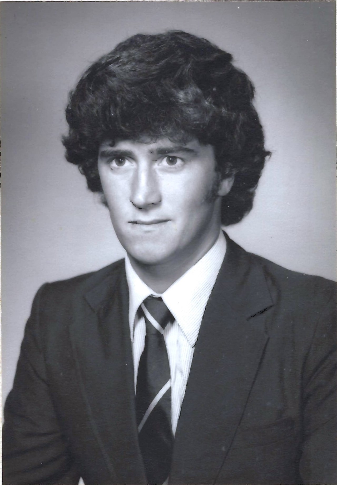 A black-and-white portrait of John
