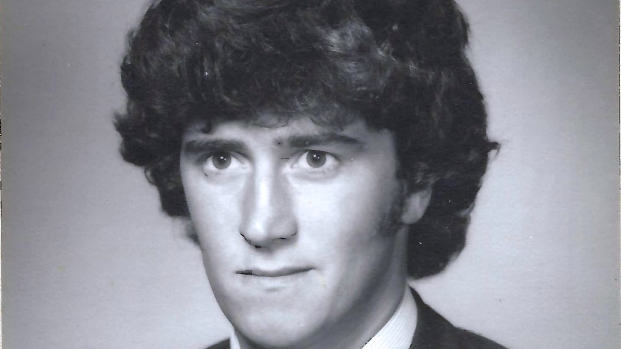 A black-and-white portrait of John