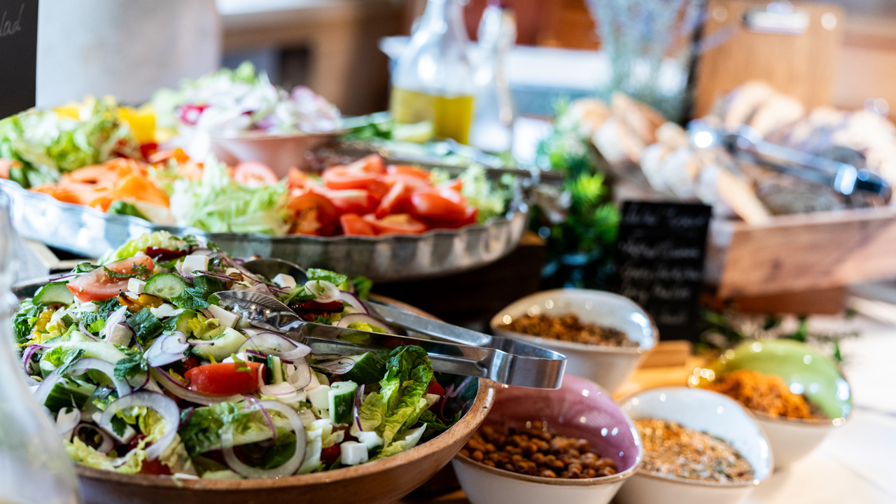 Closeup view of buffet lunch salads and toppings.