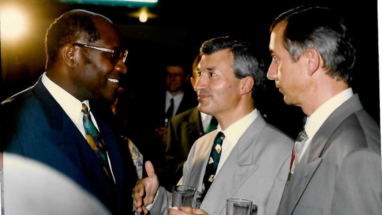 Richard and his partner in suits meeting with the Prime Minister of Ivory Coast who is also wearing a suit