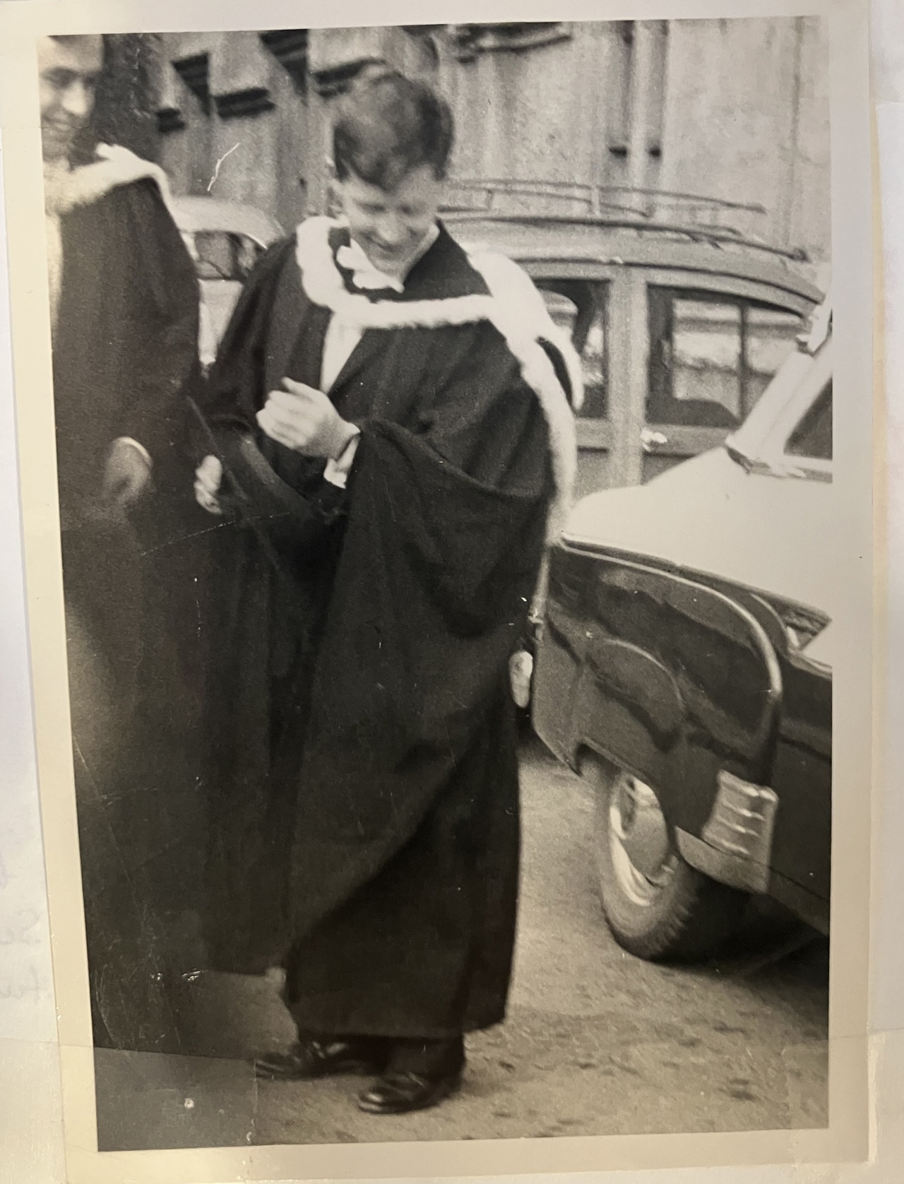 A black-and-white picture of Bob wearing a gown for the degree ceremony