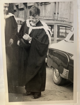 A black-and-white picture of Bob wearing a gown for the degree ceremony