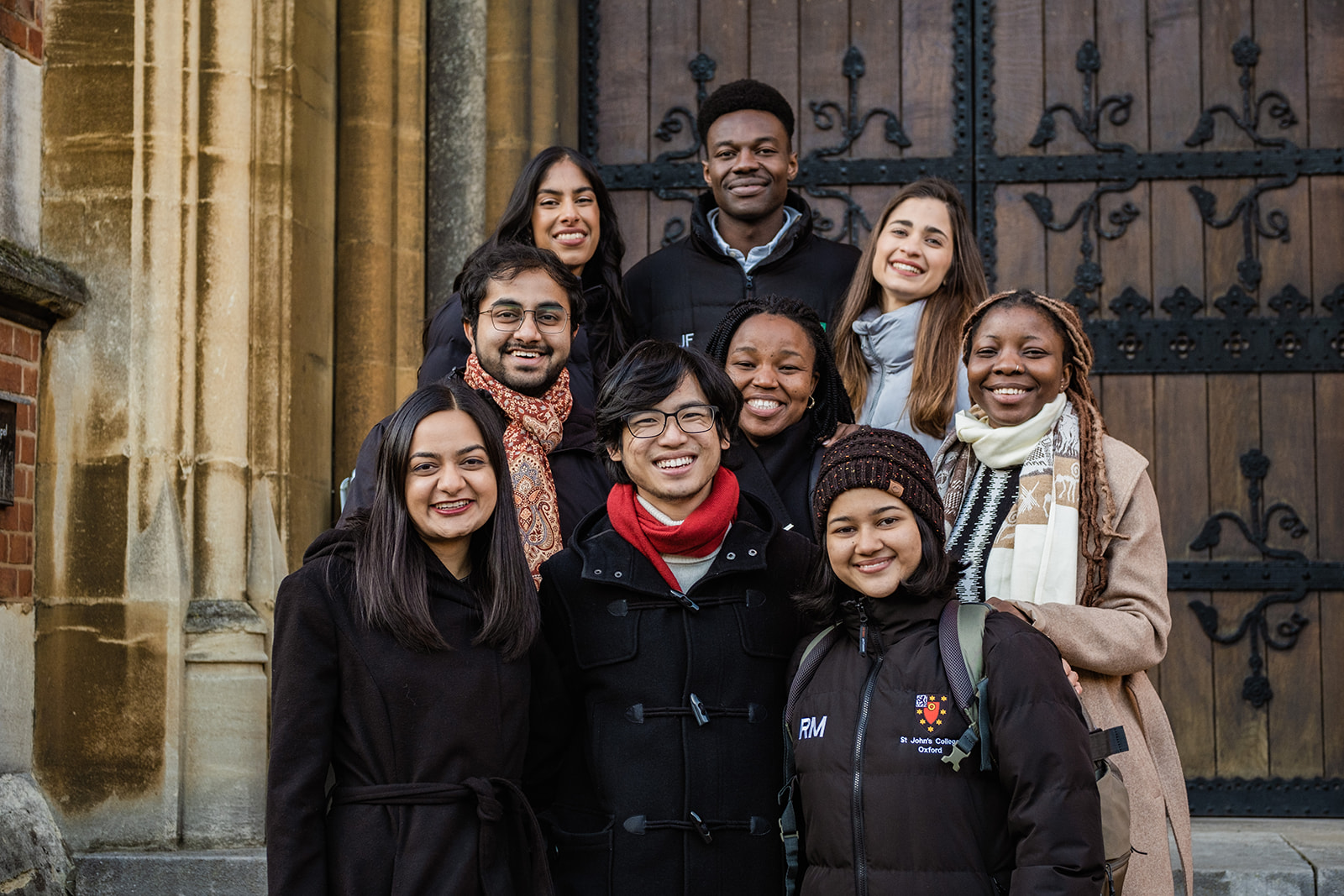 A group of Rhodes Scholars smiling and posing for a photograph.