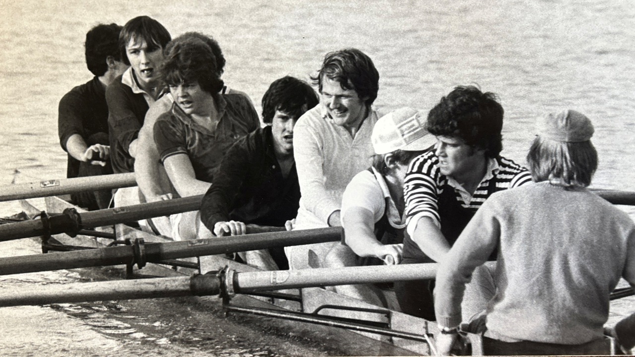 A black-and-white picture of a group of rowers.