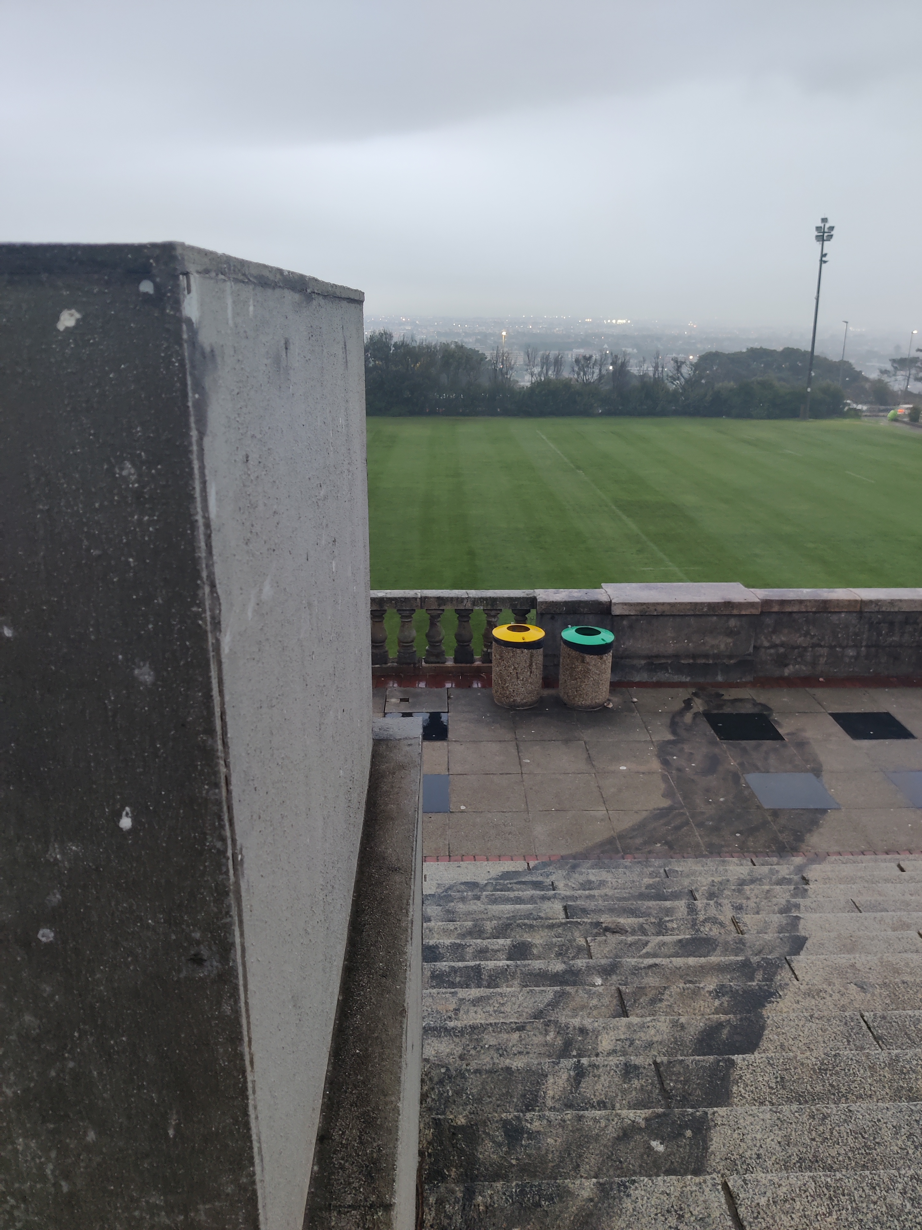 An empty plinth that housed the statue of Rhodes at UCT, with a long shadow painted in black down the staircase.