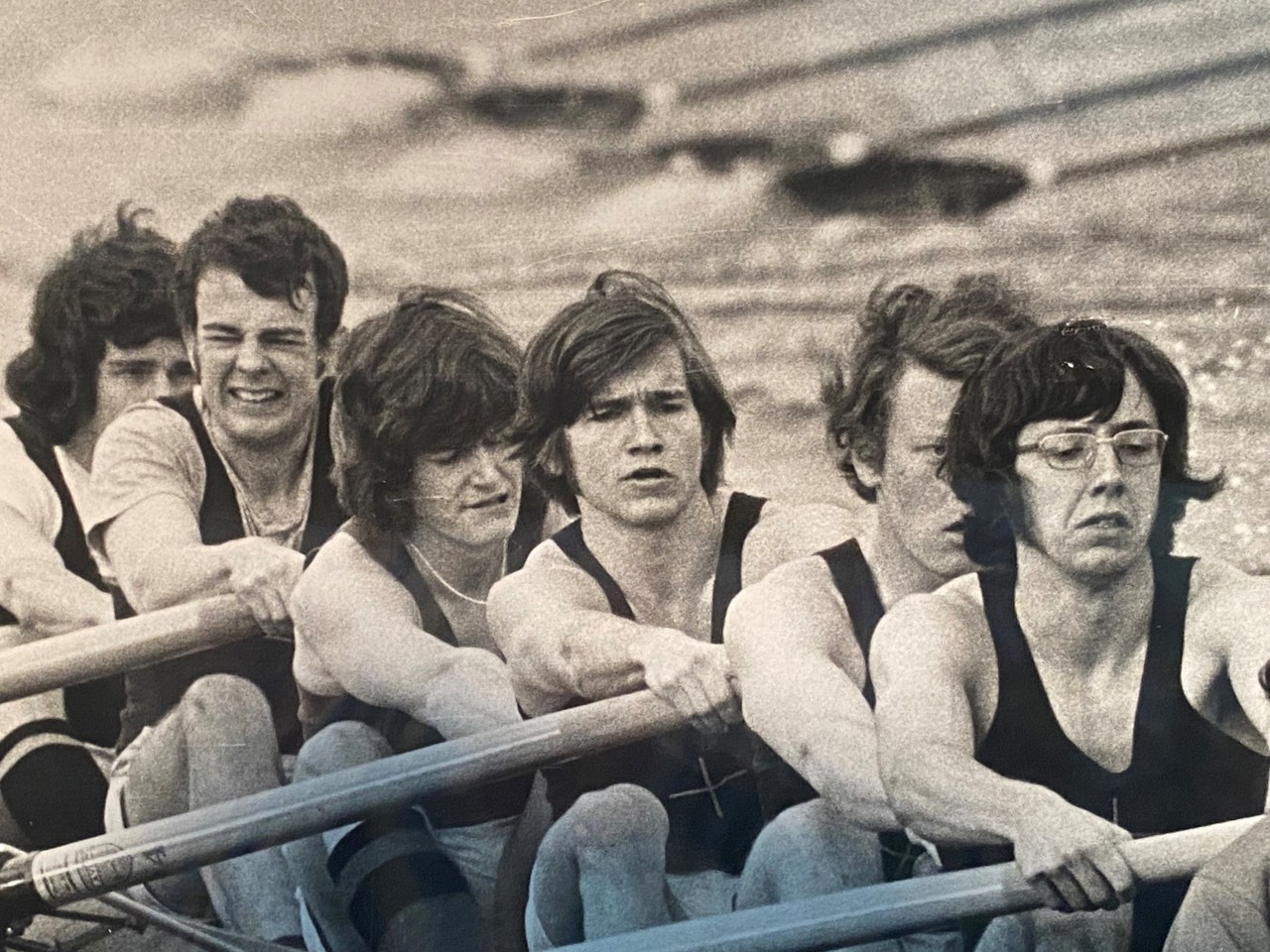 A black-and-white picture of Jack rowing with a few other men