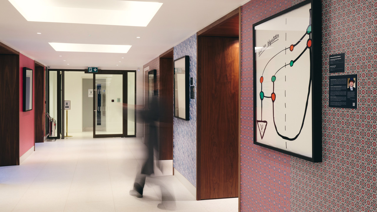 Guests walking through the corridor holding the exhibition