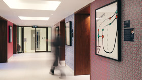 Guests walking through the corridor holding the exhibition