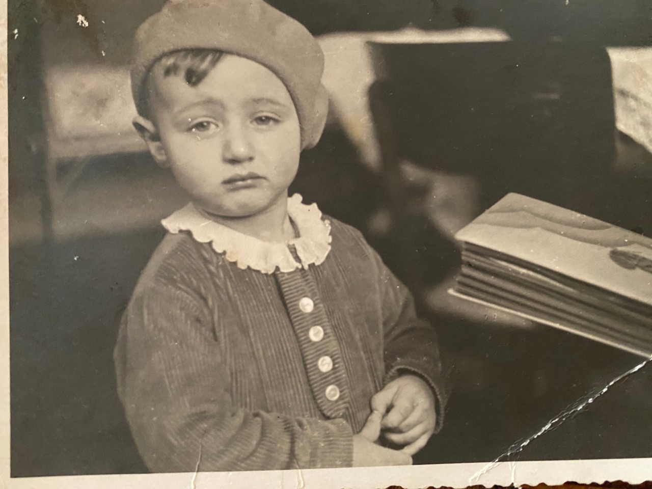 Black and white photo of Erich as a baby wearing a beret and looking grumpy.