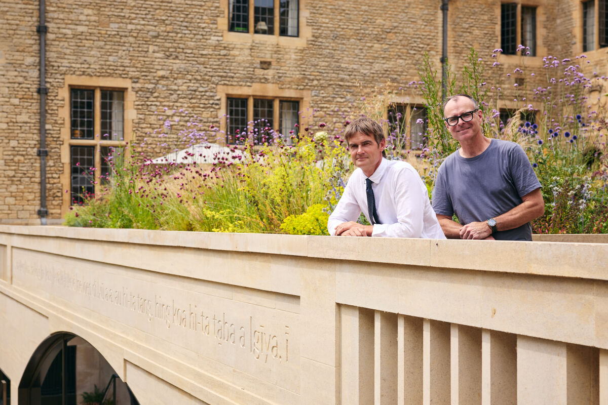 Fergus Wessell and Mat Davies standing behind the parapet carving