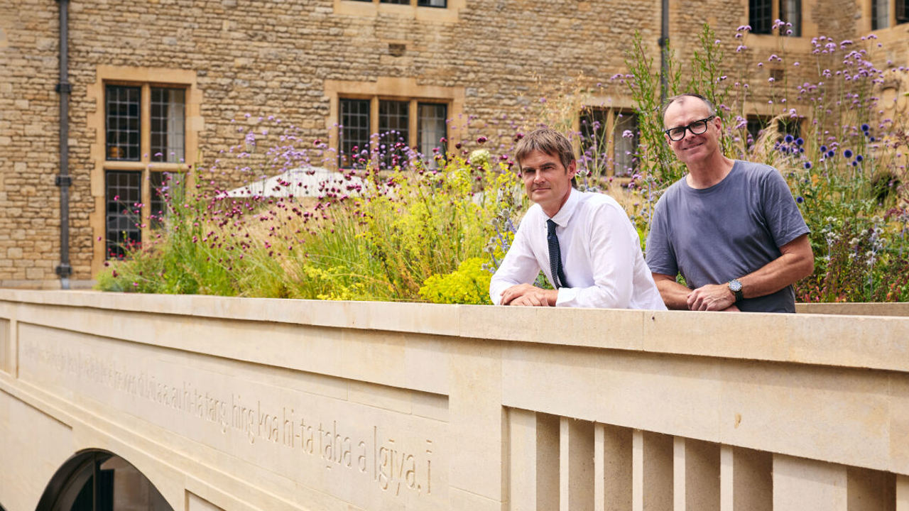 Fergus Wessell and Mat Davies standing behind the parapet carving