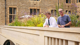 Fergus Wessell and Mat Davies standing behind the parapet carving