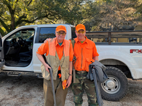 Peter stood to the left, with son to his right, both wearing fluorescent orange.