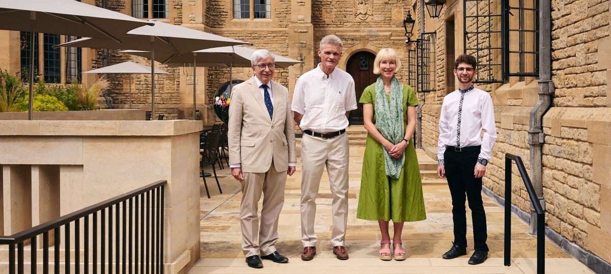 Group of Warden, Chairman, Trustee and Translator standing next to the parapet