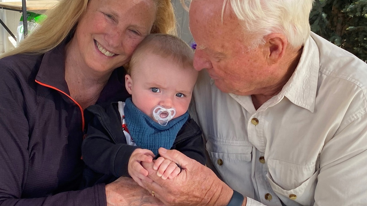The picture shows Richard and another woman holding a baby.