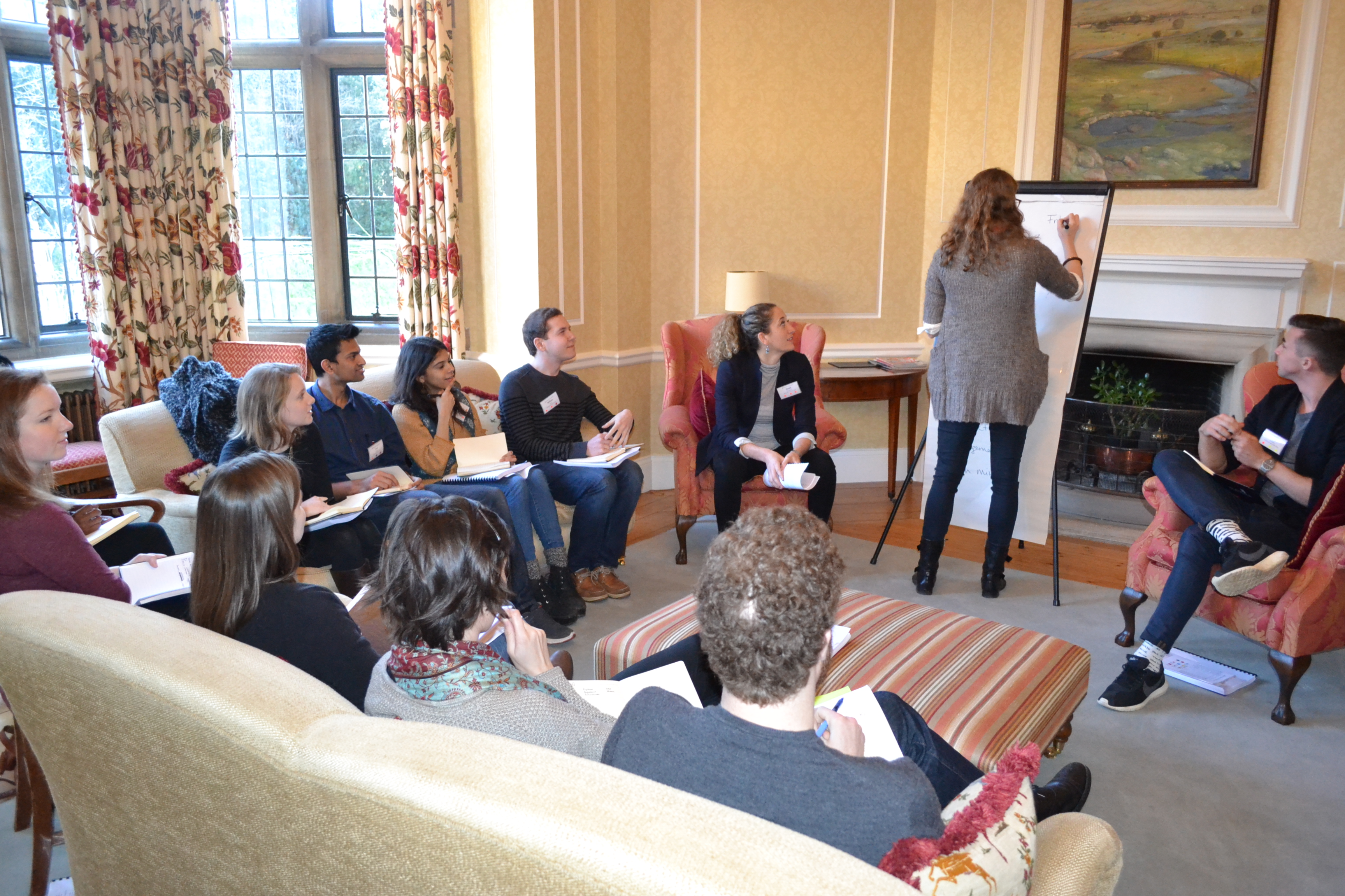1St Year Retreat 2016 Scholars Sat In A Circle Watching A Scholar Write On The Flipchart