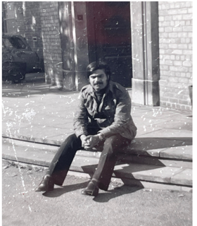 A black-and-white picture of Jahar seated outside the physiology laboratory