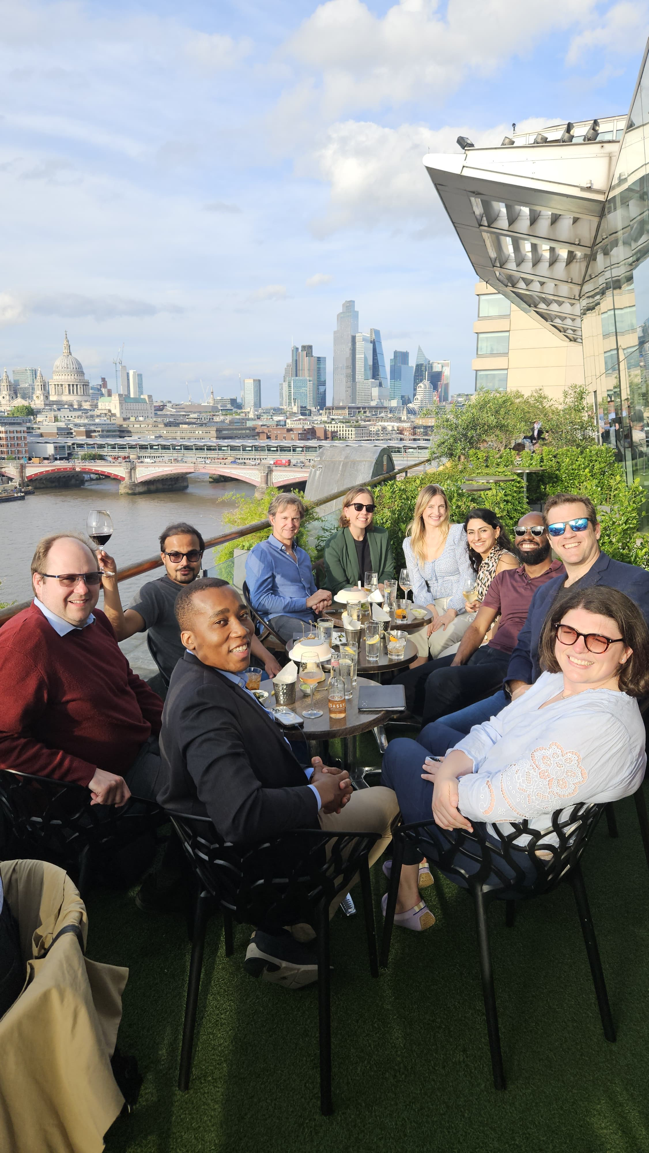 Rhodes Scholars out for drinks with the London skyline behind them