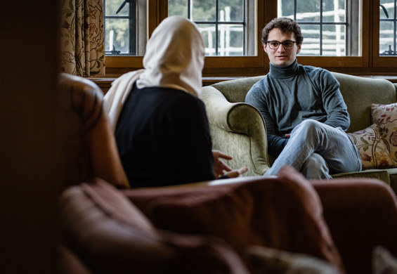 Two scholars sitting in coversation