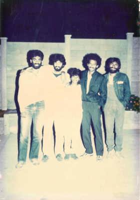 The picture is faded and shows a group of boys in shirts and baggy jeans