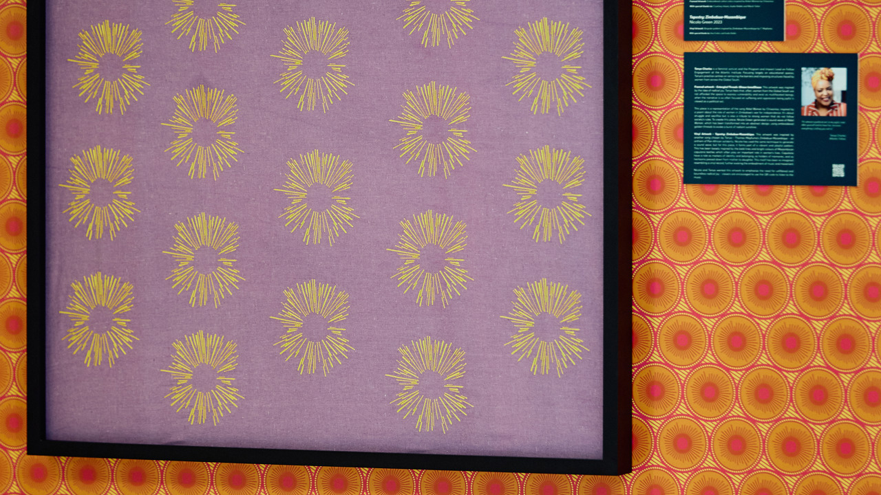 A vibrant pink and orange patterned artwork loosely inspired by the bold lines and bright colours of Mozambican capulana textiles