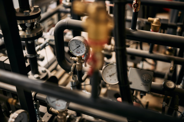 Close up photo of plumbing pipes at Rhodes House