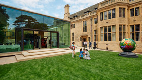 Guests on the Rhodes House West Lawn in front of the Glass Pavilion