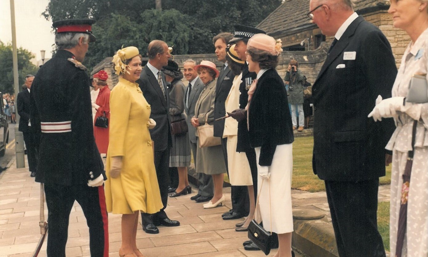 An image of her Majesty Queen Elizabeth II and Prince Philip being greeted at Rhodes House in 1983