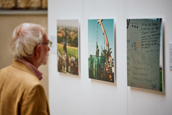Older Man Looking At The Photographs Part Of The Exhibition By Shadreck
