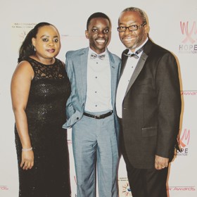 Kenneth on the right with his family to the left of him. All in smart occasinon wear.