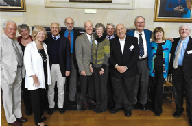 A picture showing a group of Rhodes Scholars, smartly dressed and smiling.
