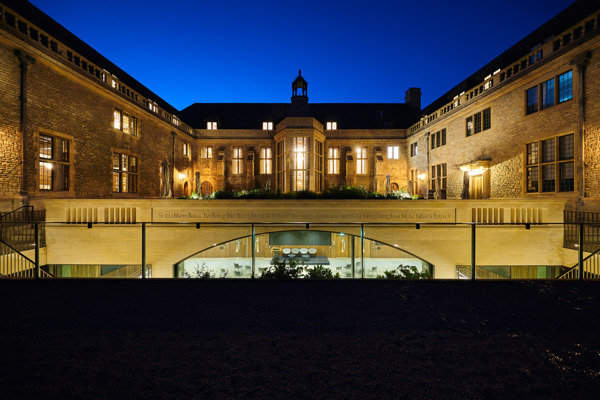 View of the Courtyard at night with lights coming from the windows and the Conference Hall below.