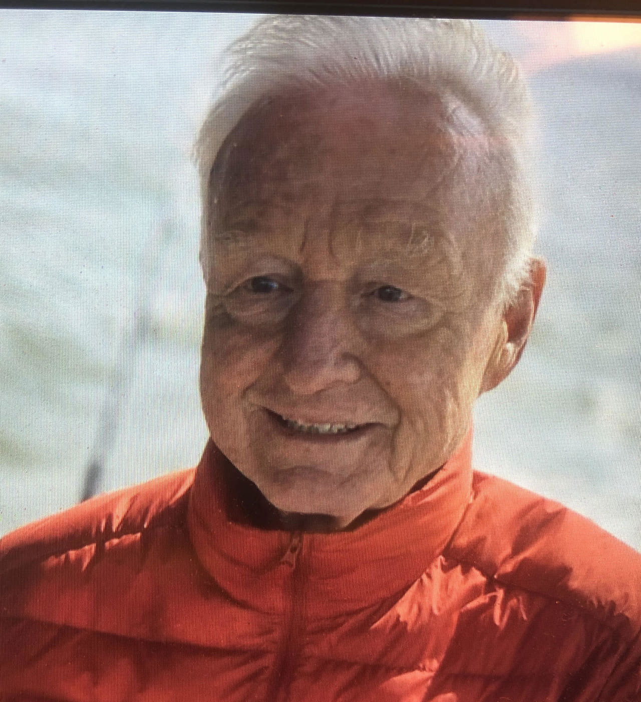 The picture is a close-up shot of Richard's face, wearing a red puffer jacket.