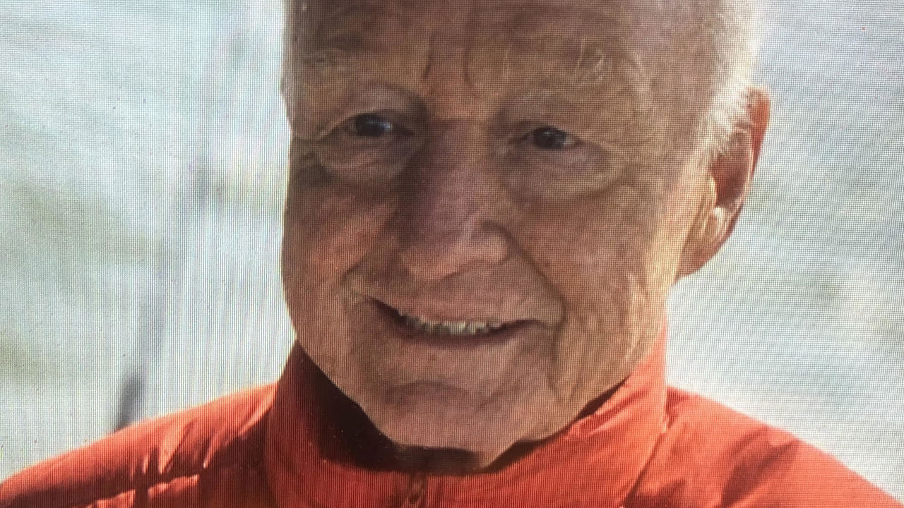 The picture is a close-up shot of Richard's face, wearing a red puffer jacket.
