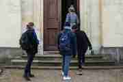 Four Scholars walking through on open college door