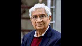 A close-up portrait of Deepak in a blue jumper and a navy jacket